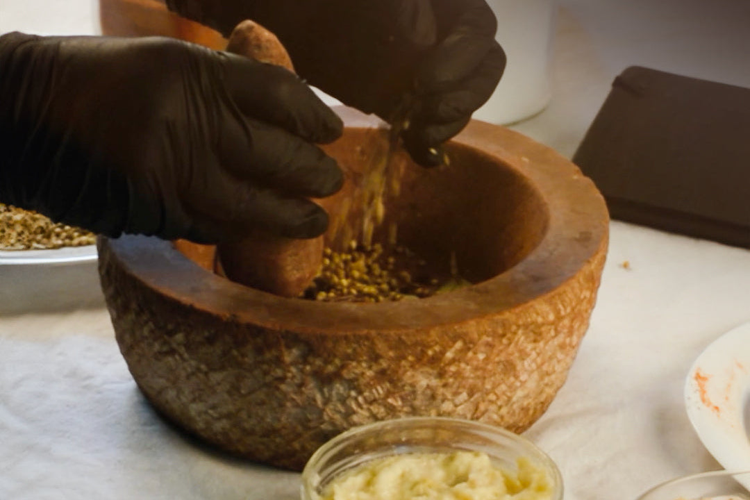 Person grinding ingredients in a mortar with text about love and magic.